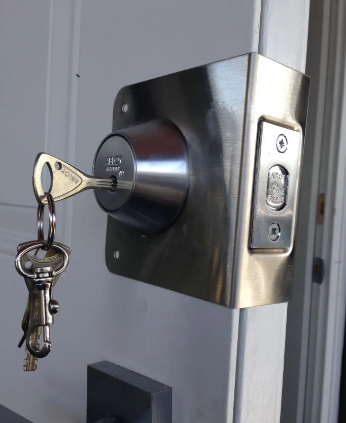 Grade 1 deadbolt being installed on a front door