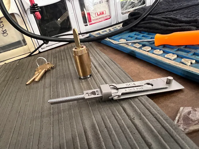 Locksmith rekeying a residential door lock cylinder in Indialantic, FL