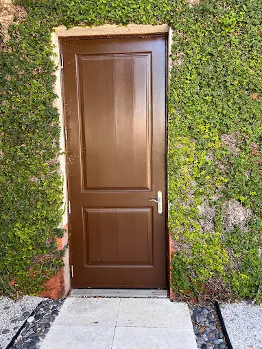 Multi-point hurricane lock system on residential entry door with three locking points visible