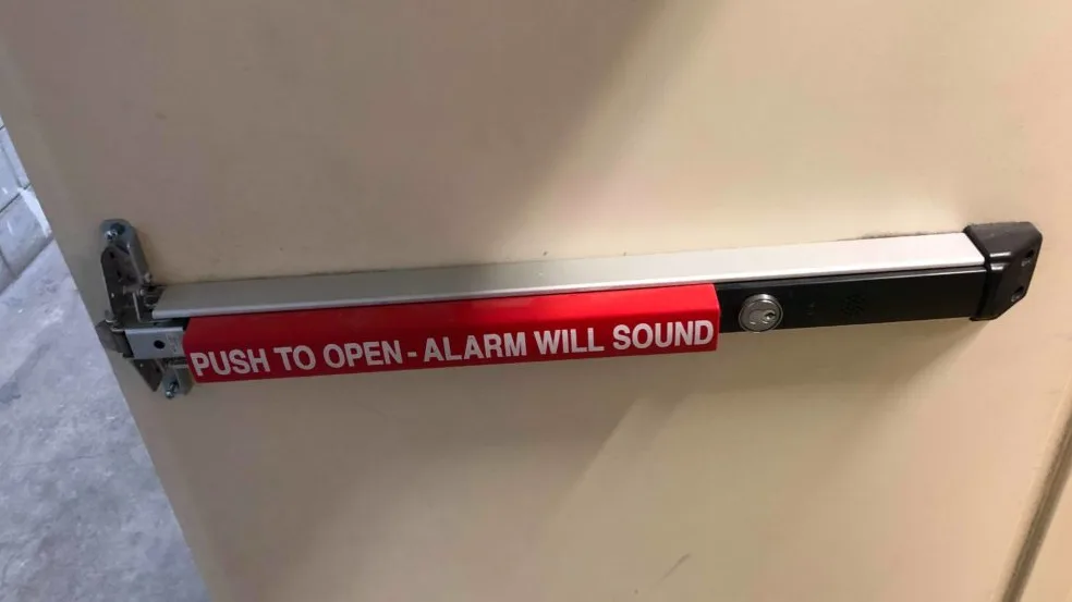 Von Duprin panic bar installation on a commercial exit door